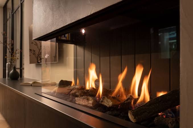 Modern built-in fireplace with a wide glass front