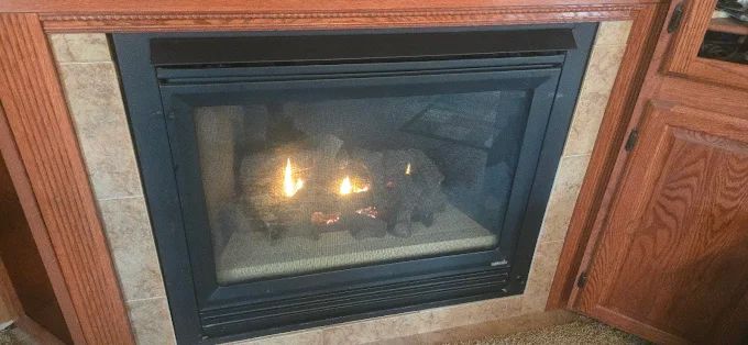 Modern gas fireplace with clean flames and glass front