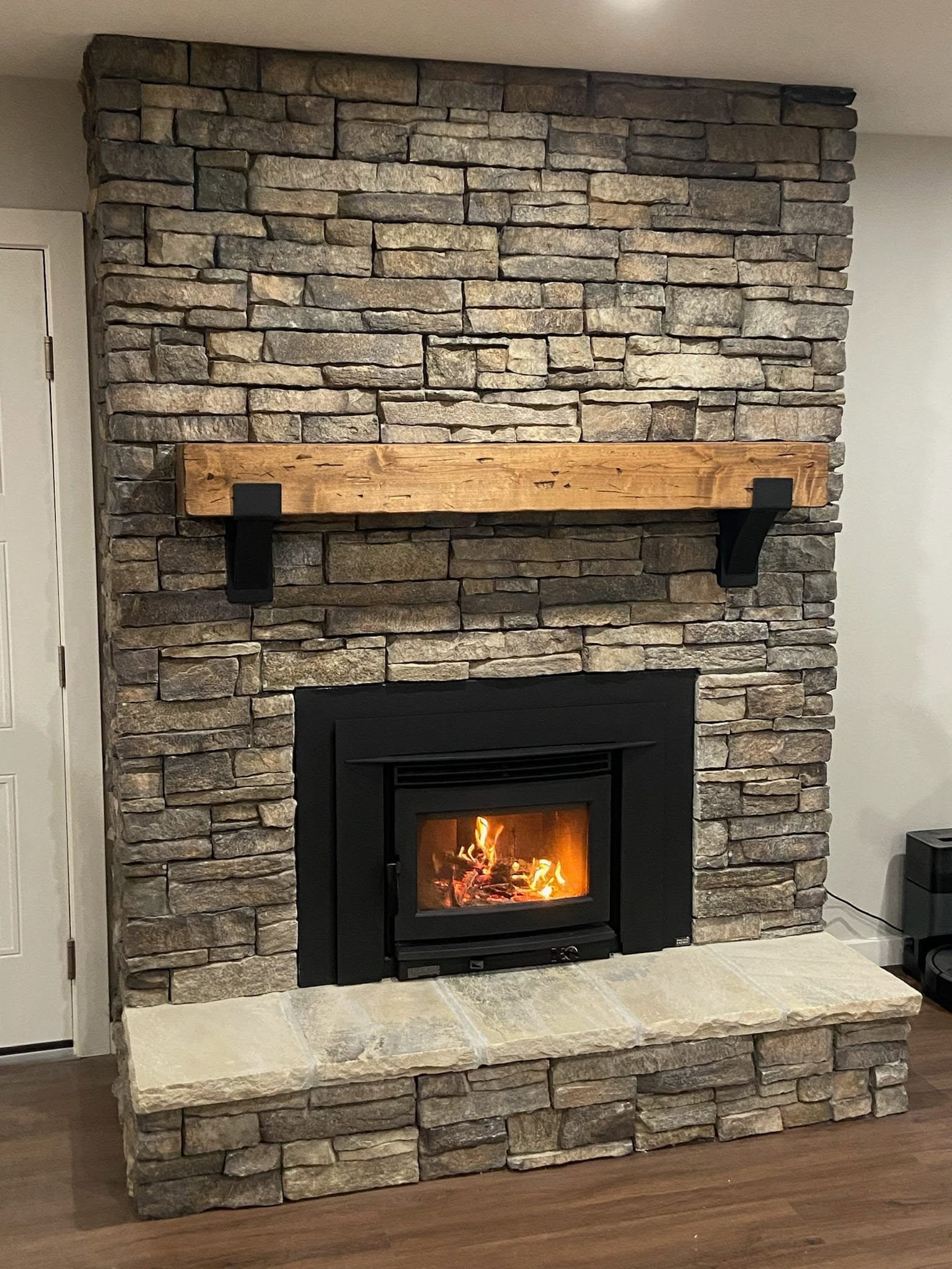 Stone fireplace with insert and mantel